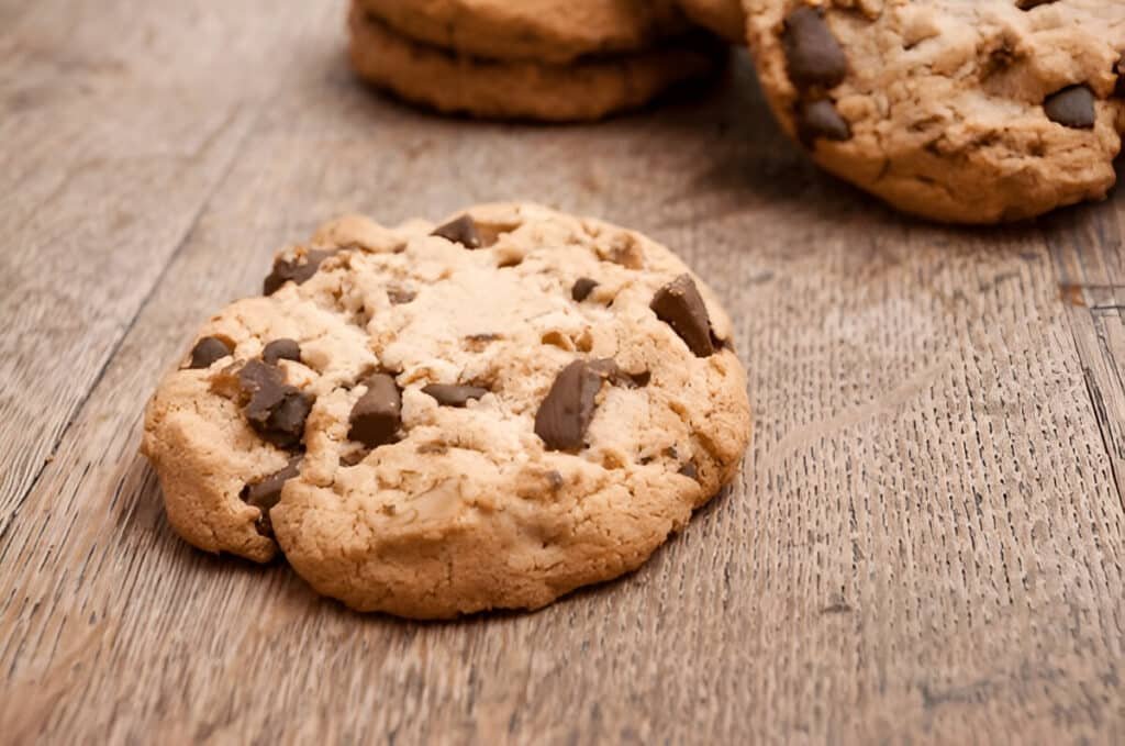Chocolate chip cookie on rustic wooden background