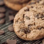 Homemade chocolate chip cookie on dark wooden board