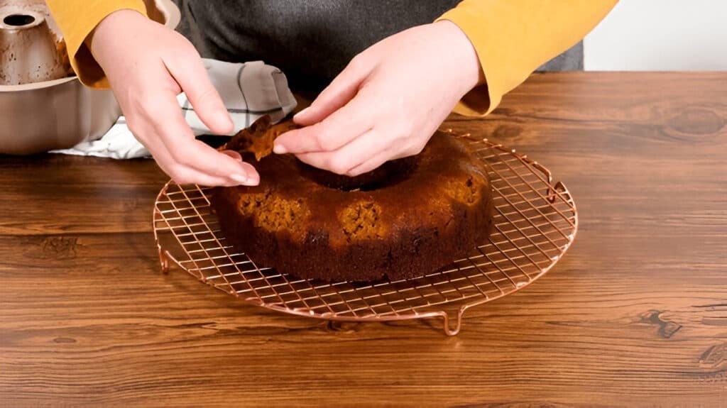 Removing bundt cake from pan onto cooling rack