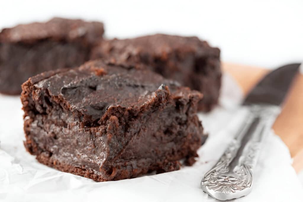 Sweet potato cocoa brownie with crackly top on parchment paper