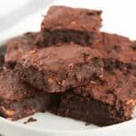 Stack of sweet potato cocoa brownies on a white plate