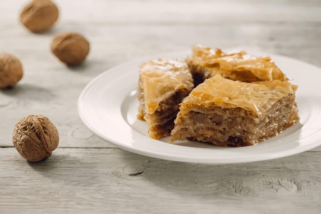 Greek baklava slices with walnuts and honey syrup on a plate