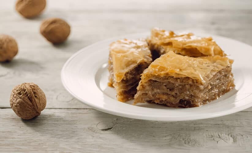 Greek baklava slices with walnuts and honey syrup on a plate