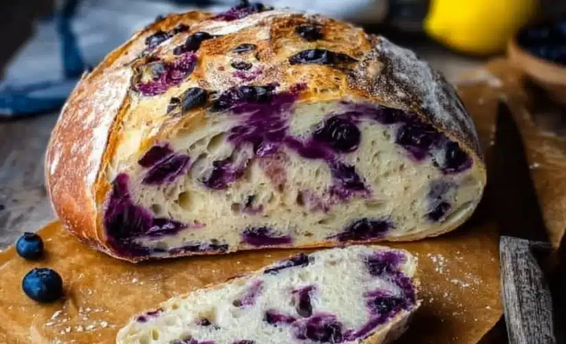 Freshly baked lemon blueberry sourdough bread with a golden crust