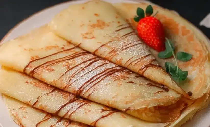 Delicious eggless crepes filled with fruits and toppings on a plate