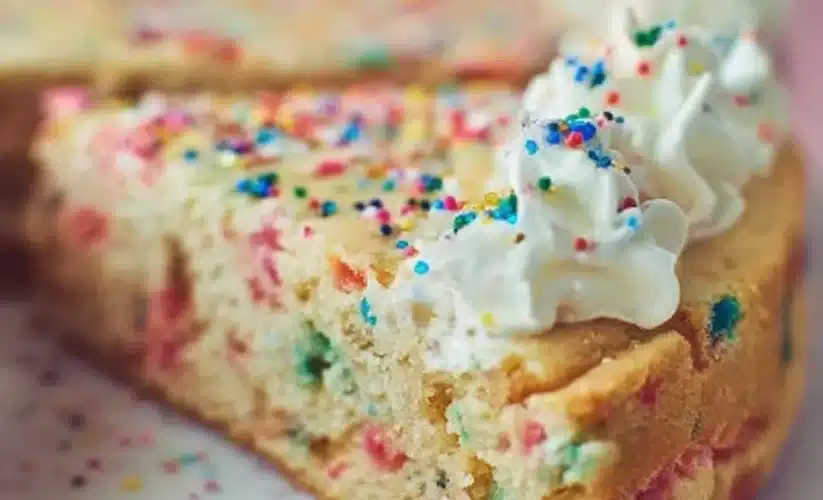 Delicious Funfetti Sugar Cookie Cake topped with colorful sprinkles
