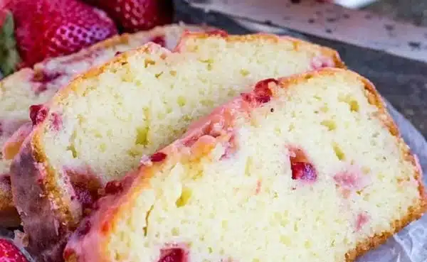 Delicious strawberry pound cake with fresh strawberries and creamy frosting